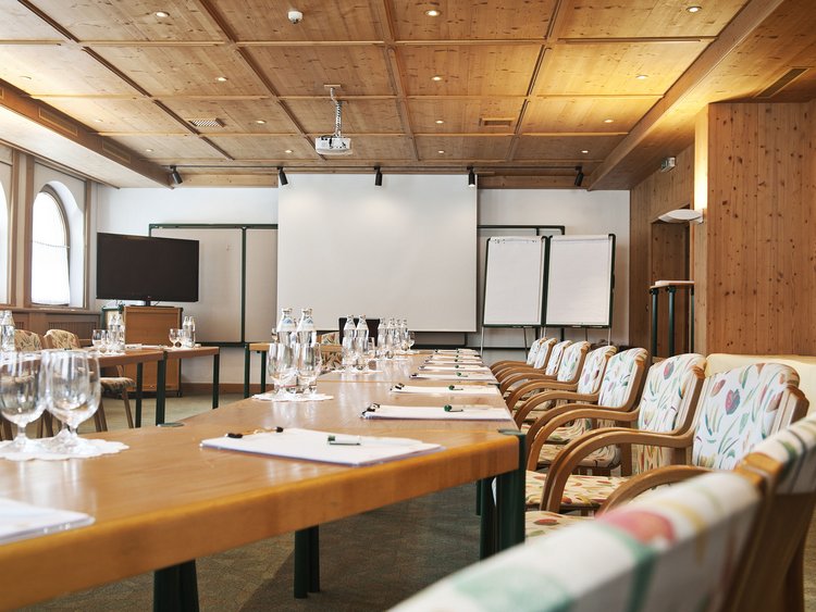 Inspiring incentives at the luxury seminar hotel in Tyrol Conference room setup with tables, chairs, and presentation equipment.