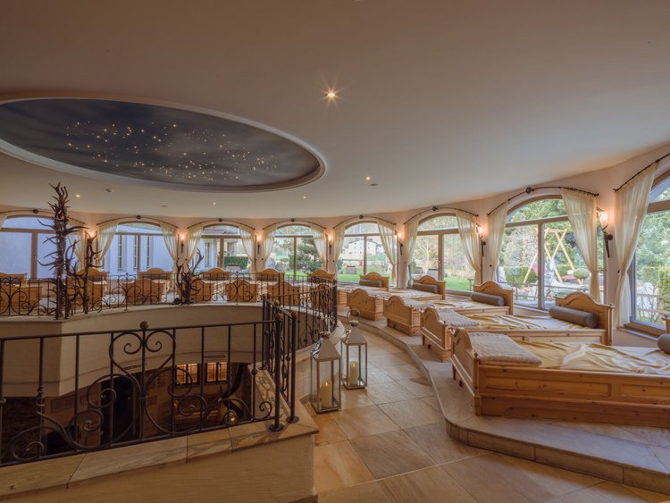 Relax room with wooden benches, large windows, and starry ceiling