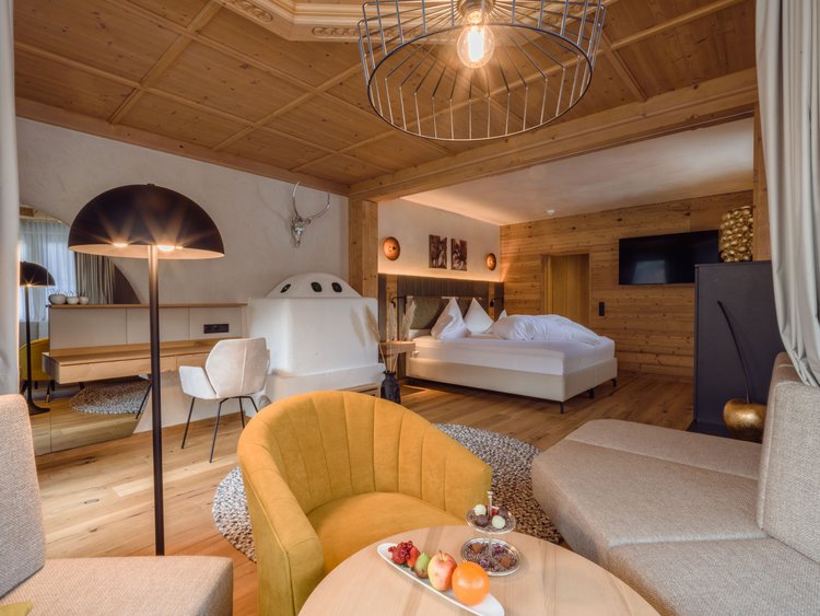 One of the most romantic hotels in Austria Modern hotel room with wooden ceiling and cozy seating area