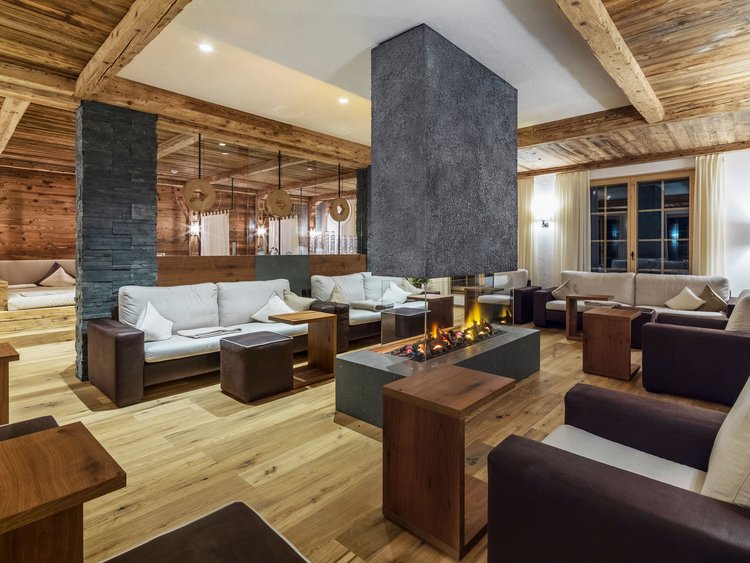 Modern living room lounge with fireplace and wooden beam ceiling